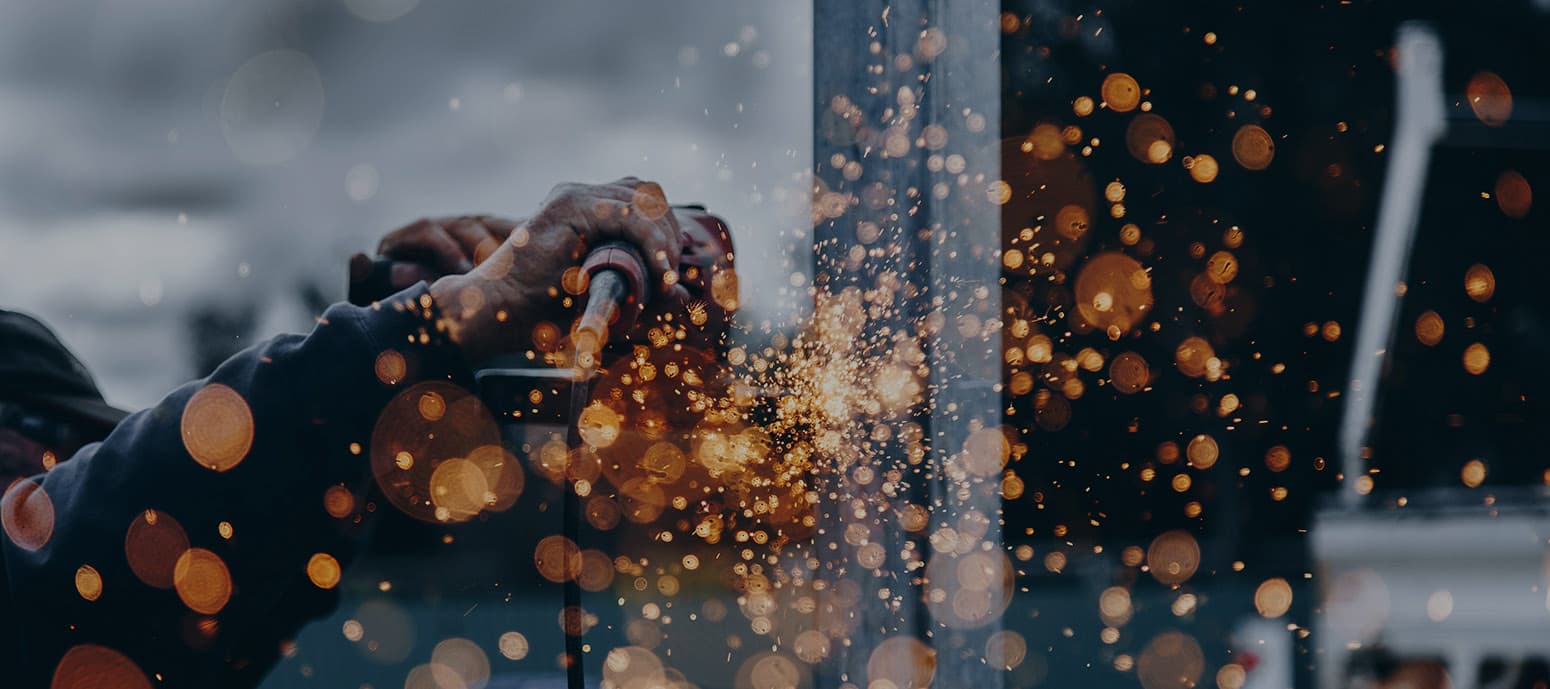 man creating sparks with a grinder